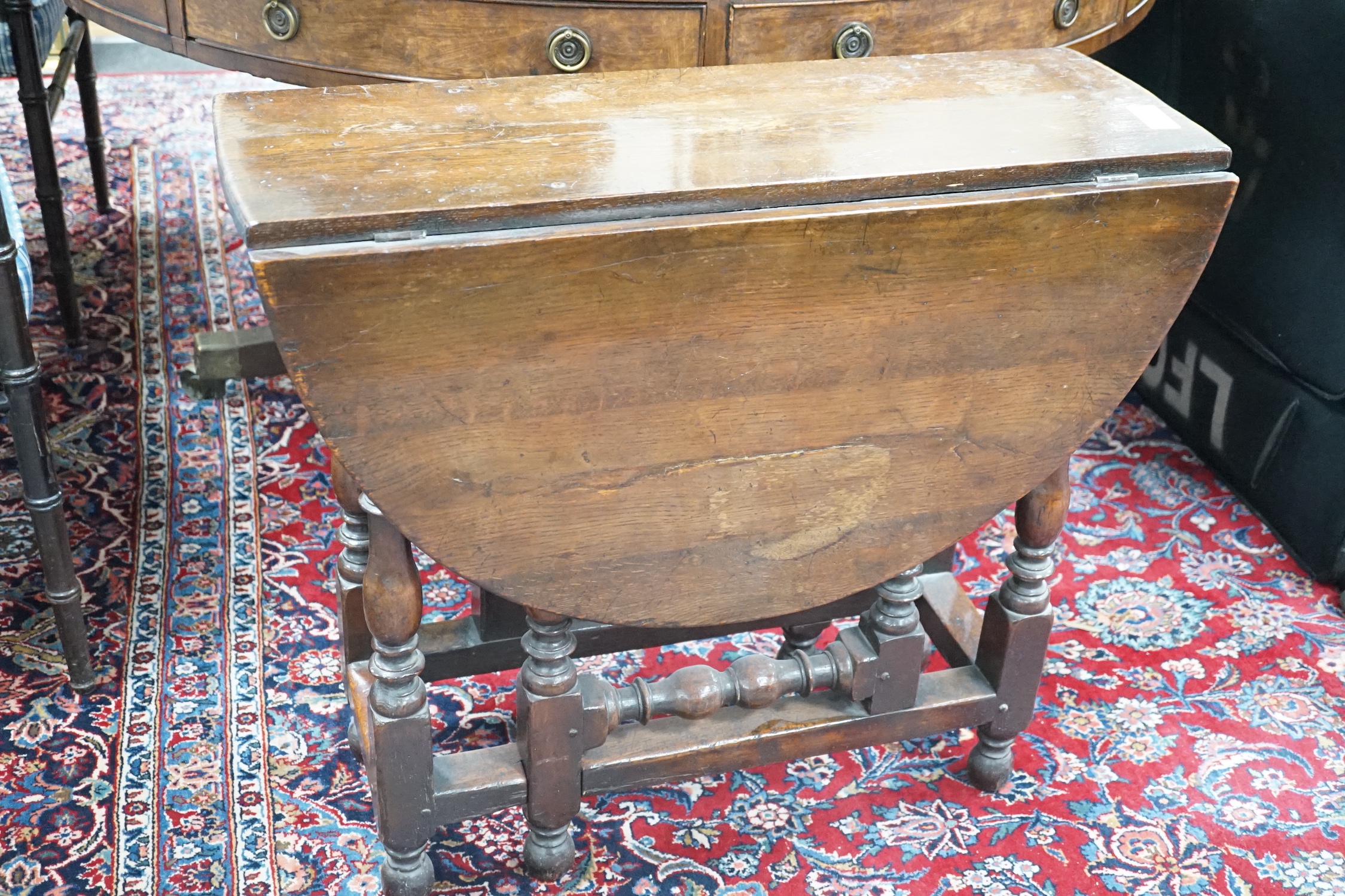 A small 18th century style oak gateleg table, width 76cm, depth 28cm, height 67cm
